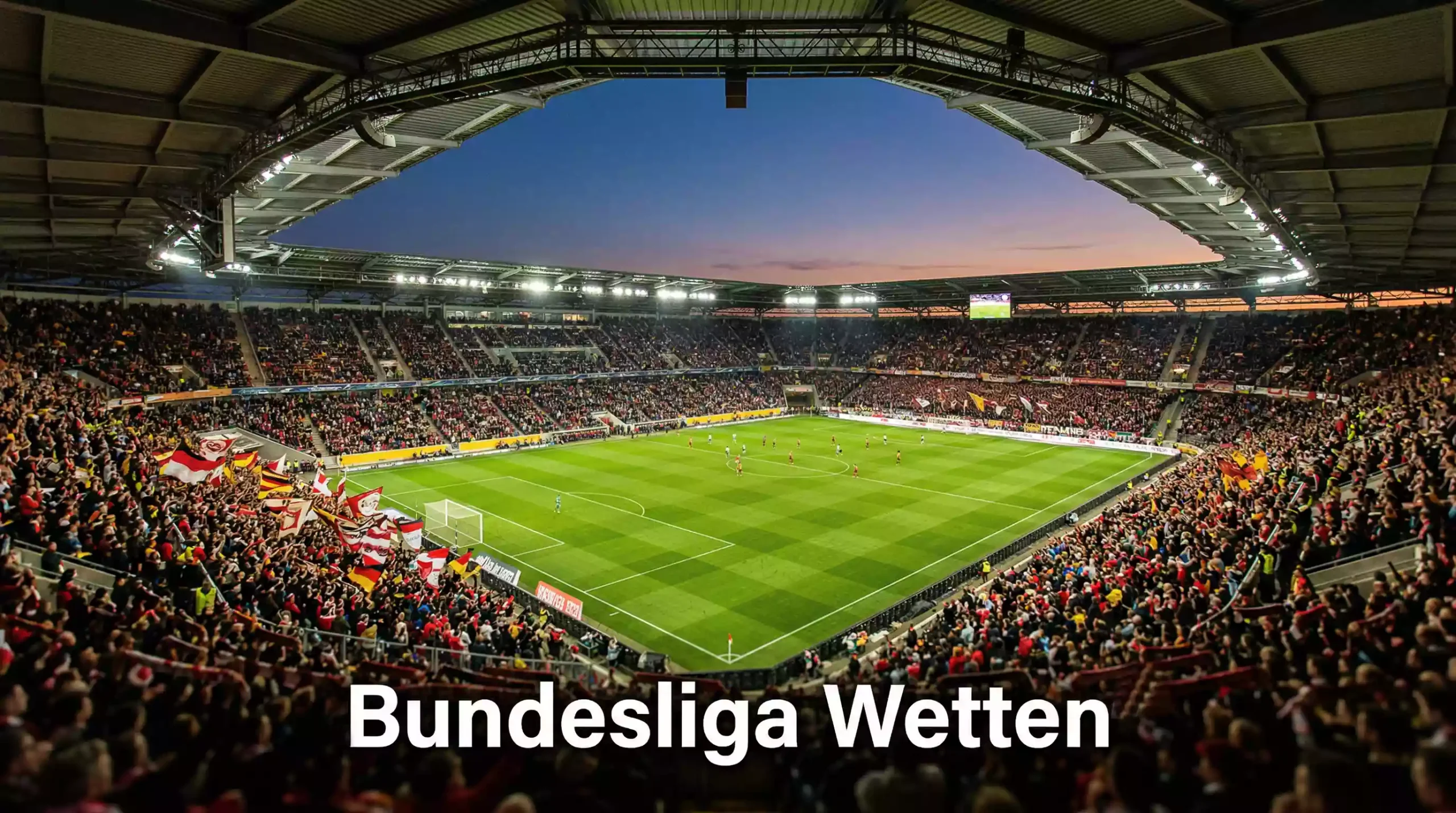 Bundesliga Wetten — Blick auf ein volles Fußballstadion mit Rasenplatz bei Flutlicht