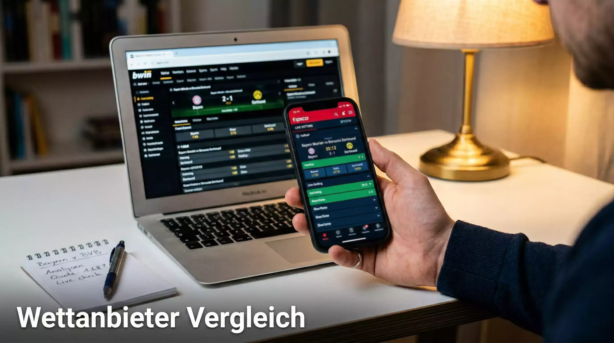 Wettanbieter Vergleich — Smartphone mit Sportwetten-App neben Laptop auf einem Schreibtisch